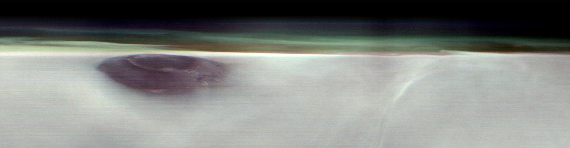Arsia Mons, an ancient Martian volcano, was captured before dawn on May 2nd, 2025, by NASA’s 2001 Mars Odyssey orbiter while the spacecraft was studying the Red Planet’s atmosphere, which appears here as a greenish haze. Credit: NASA/JPL-Caltech/ASU