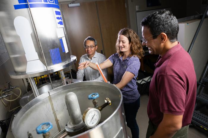 Drs. Zhei, Dove, and Elgohary examine the test chamber to be used for the testing. Credit - University of Central Florida / Antoine Hart