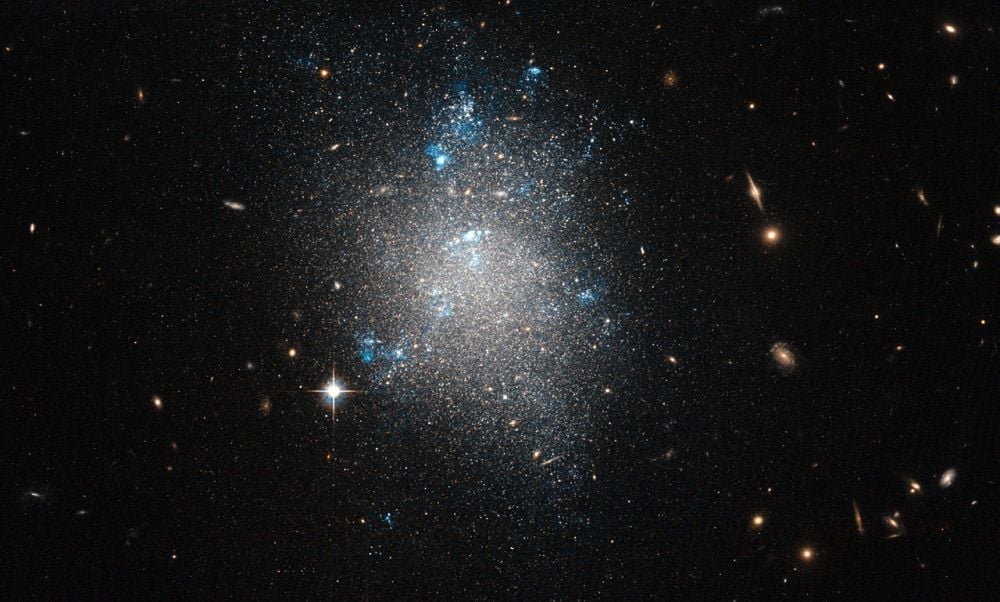 Dwarf galaxies like this one (NGC 5477) are satellites of larger galaxies like the Milky Way. New research examined 36 distant dwarf galaxies to see if they had their own, smaller satellites. The goal is a better understanding of how galaxies form and evolve in the Lambda Cold Dark Matter paradigm. Image Credit: ESA/Hubble & NASA