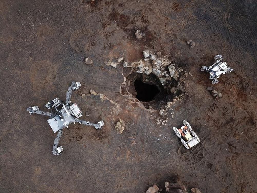 European researchers are developing a three-member team of robots that can cooperatively explore lunar caves. In this image, the robots are being tested on the Spanish volcanic island of Lanzarote. Image Credit: Aerial Skylight Robots/ University of Malaga
