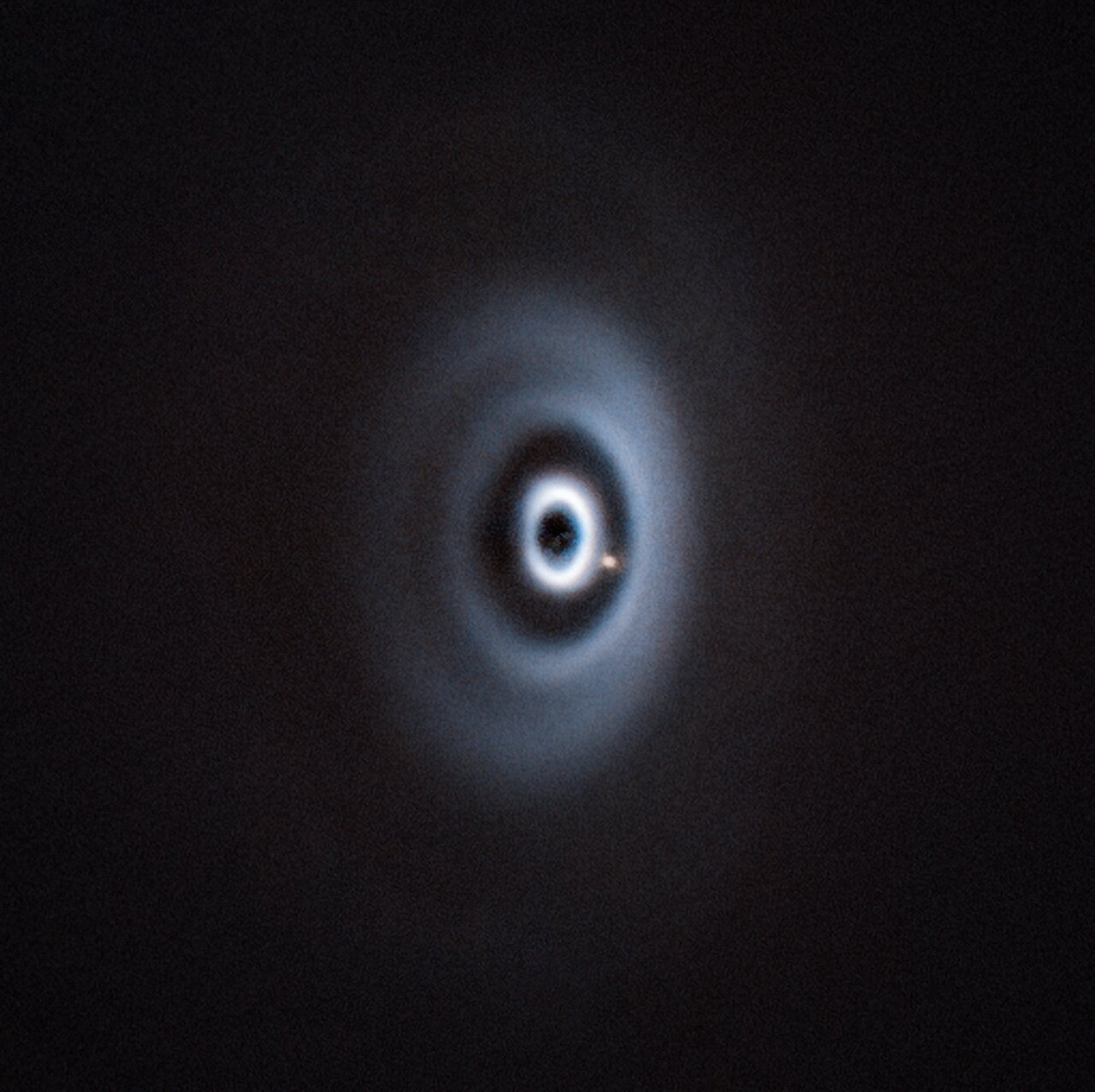 Image of the WISPIT2 system, including the bright dot of the exoplanet WISPIT2b in the gap between the rings. Credit - ESO/R. F. van Capelleveen et al.