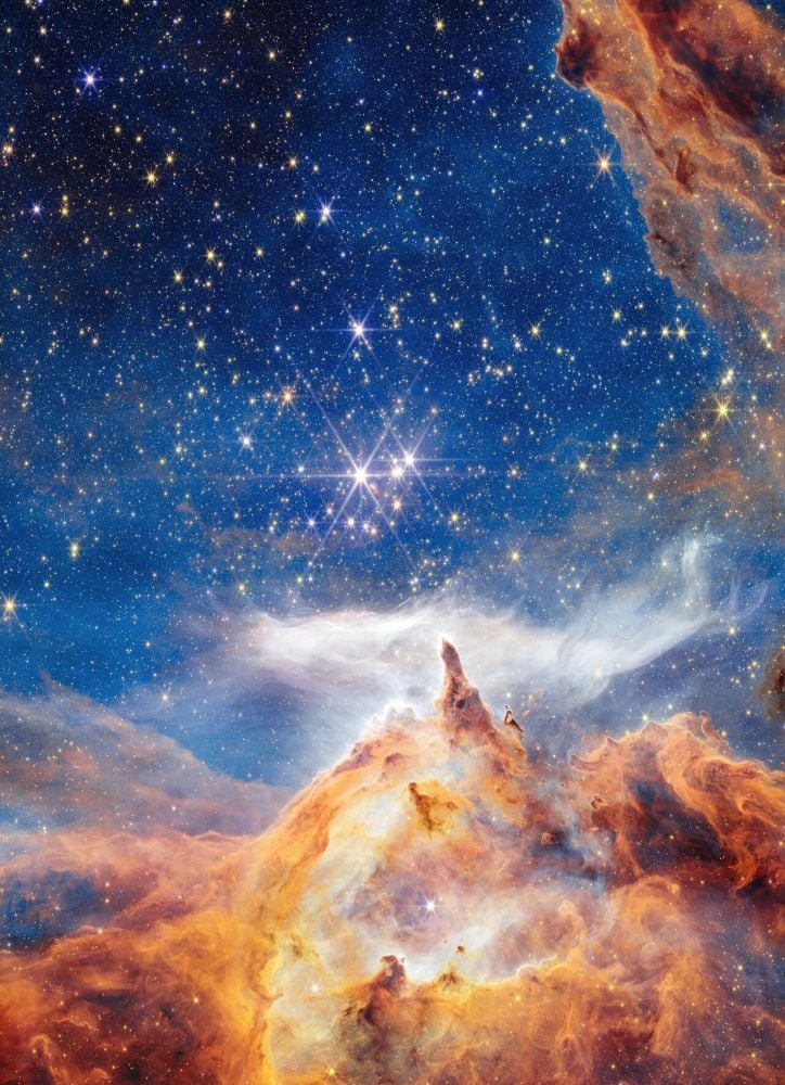 Pismis 24-1 is in the Pismis 24 star cluster. The star is in the center of this image, where the filament of gas points upward. Image Credit: NASA, ESA, CSA, and STScI, A. Pagan (STScI)