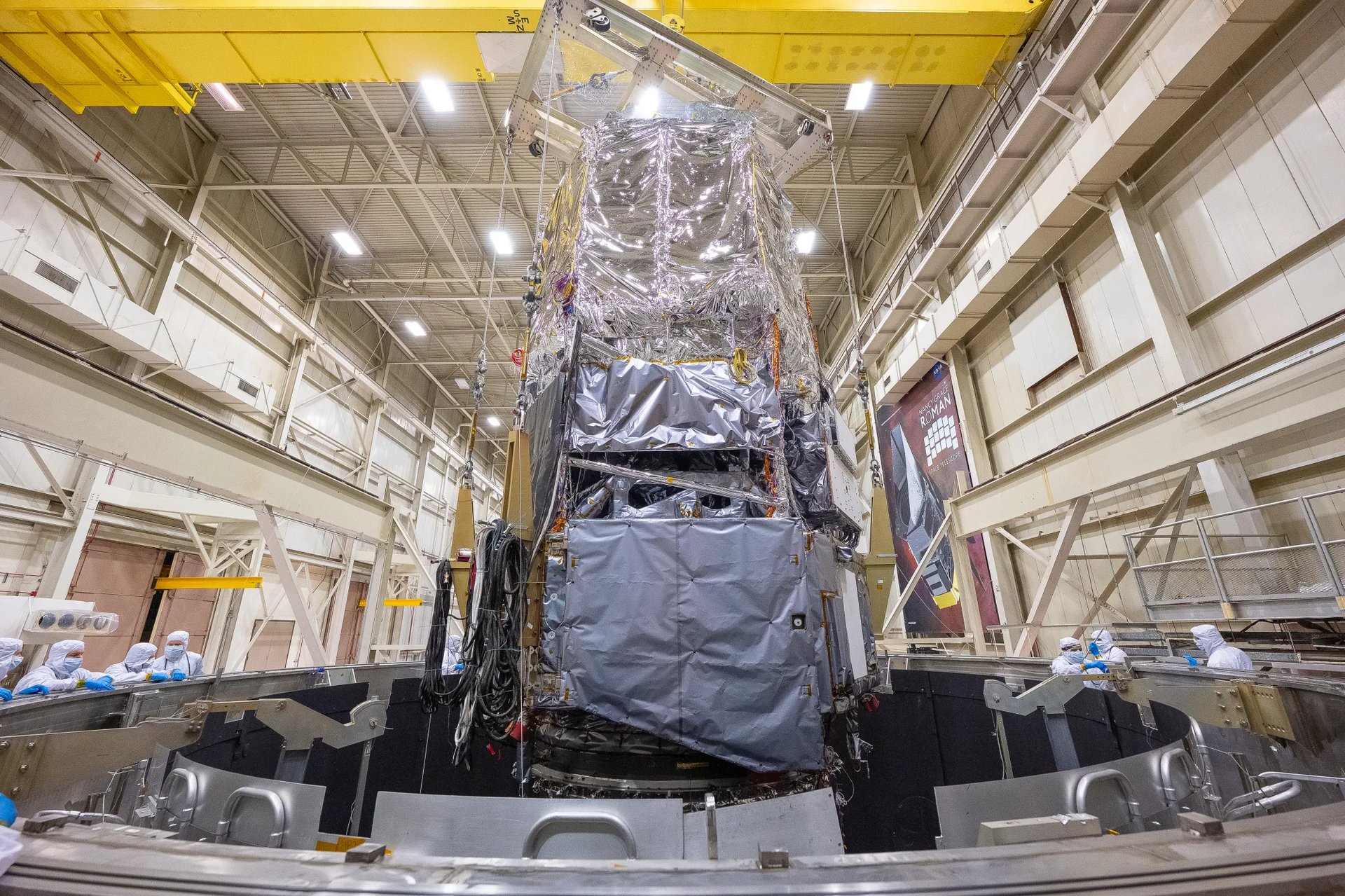Core portion of the Nancy Grace Roman Space Telescope being lifted out of the Space Environment Simulators at Goddard. Credit - NASA / Jolearra Tshiteya