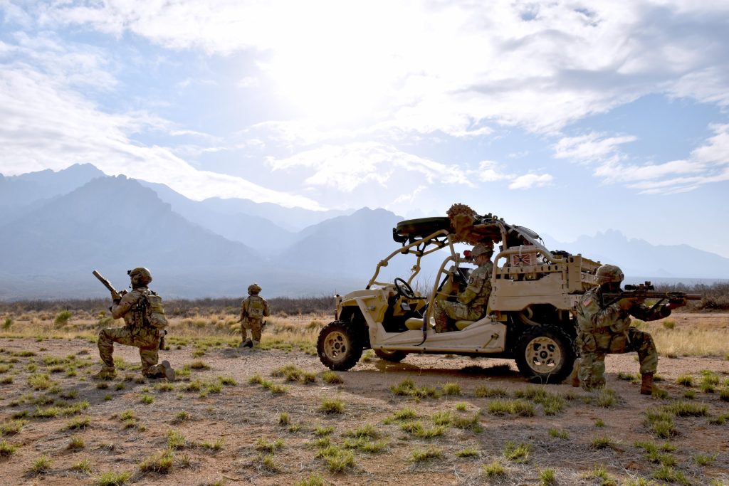 Two British Army Special Operations Brigade soldiers, left, and a Soldier with 18th Space Company, 1st Space Brigade, right, guard a small tactical vehicle equipped with a miniaturized tactical space system during Project Convergence Capstone 4 experimentation at White Sands Missile Range, Feb. 28, 2024. Credit: United States Army Space and Missile Defense Command; photo by Brooke Nevins