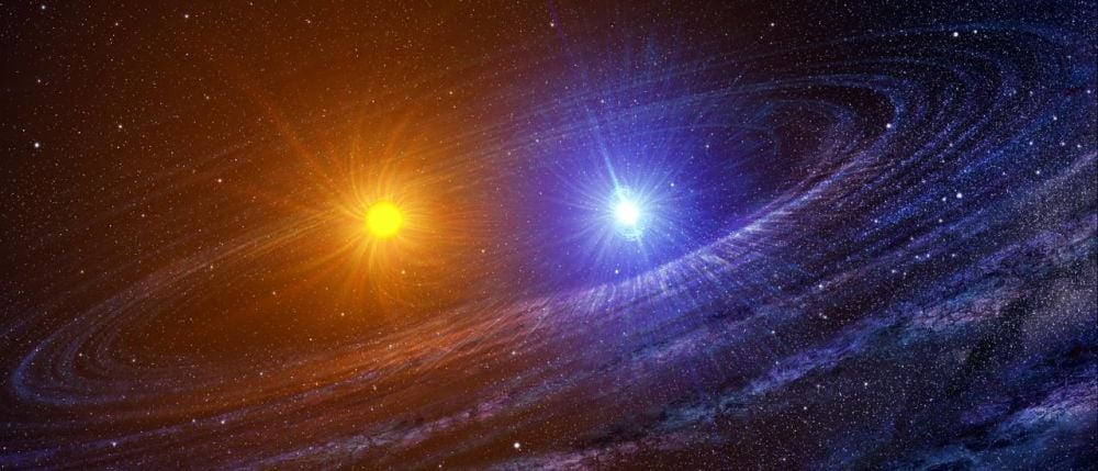 This artist's illustration shows a binary star system. While astronomers thought for a long time that planets would struggle to form in these systems, that may not be true. New research says that the opposite is likely true. Image Credit: Casey Reed, NASA.