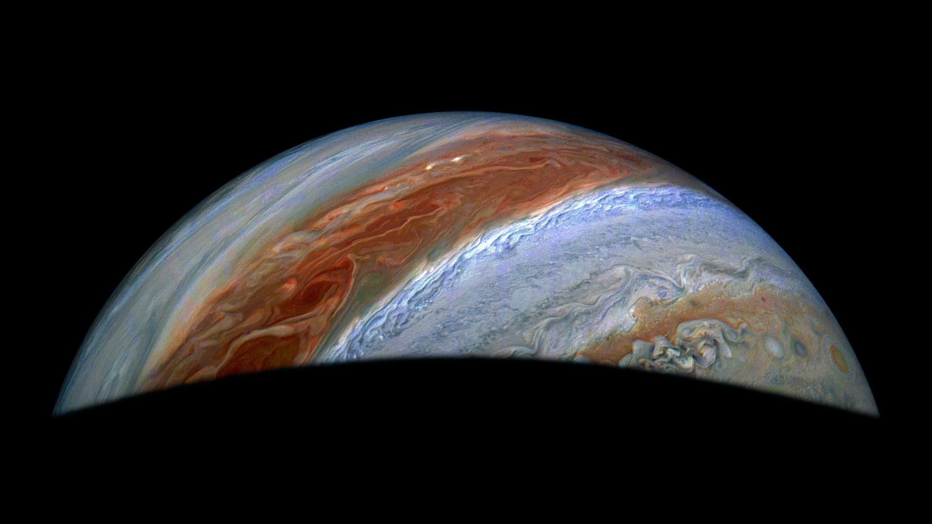 JunoCam, the visible light imager aboard NASA's Juno, captured this view of Jupiter's northern high latitudes during the spacecraft's 69th flyby of the giant planet on Jan. 28, 2025. Jupiter's belts and zones stand out in this enhanced color rendition, along with the turbulence along their edges caused by winds going in different directions.  Credits: Image data: NASA/JPL-Caltech/SwRI/MSSS, Image processing: Jackie Branc (CC BY)