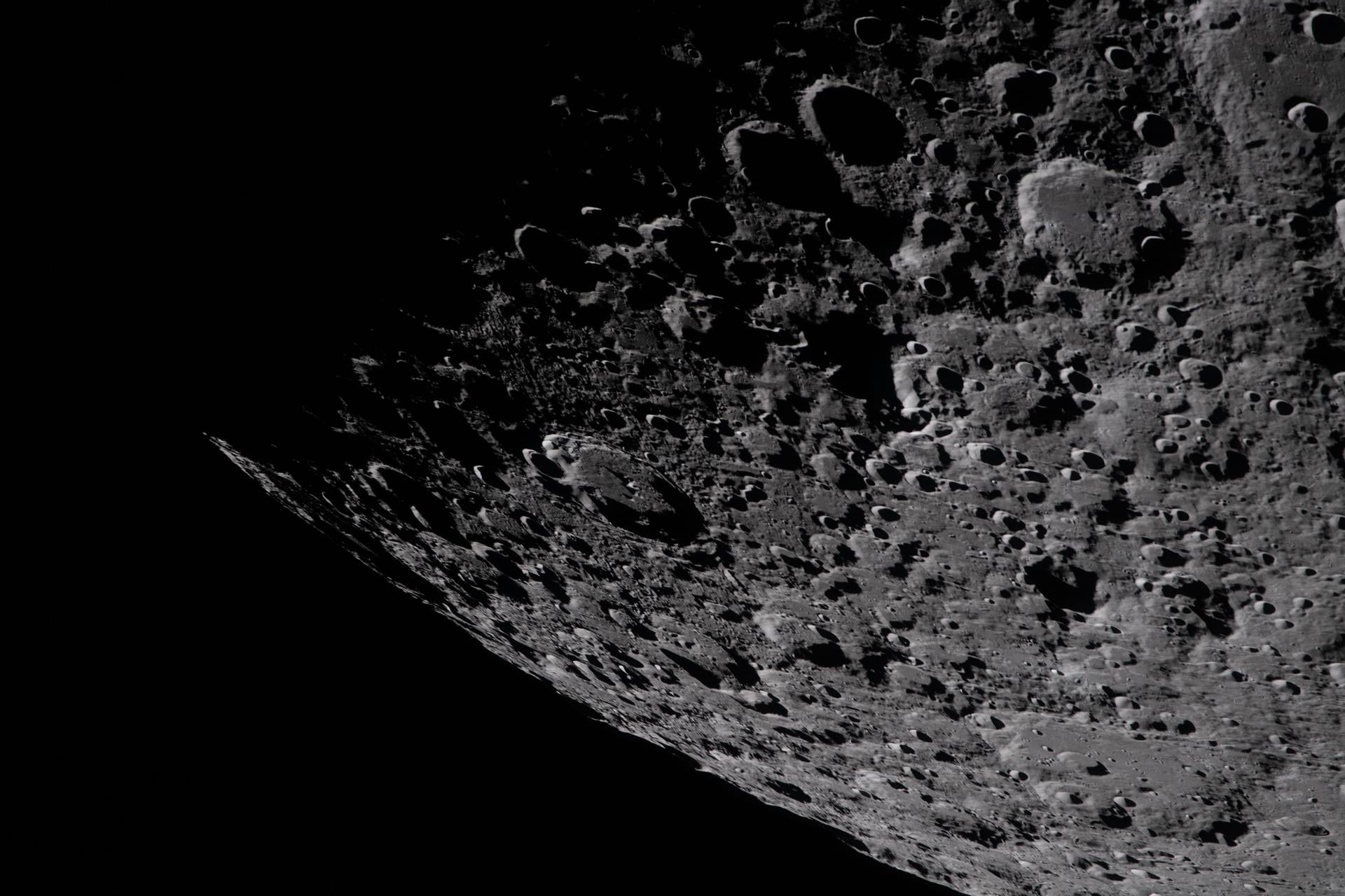 This view of the lunar south pole captured by the Artemis astronauts showes the heavily cratered terrain of the Aitken basin. Laser installations in shadowed craters could provide navigational aid to astronauts exploring the Moon. Courtesy NASA
