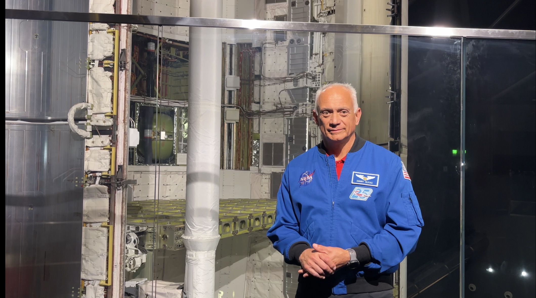 Former NASA astronaut Danny Olivas stands with the Space Shuttle Endeavor. 