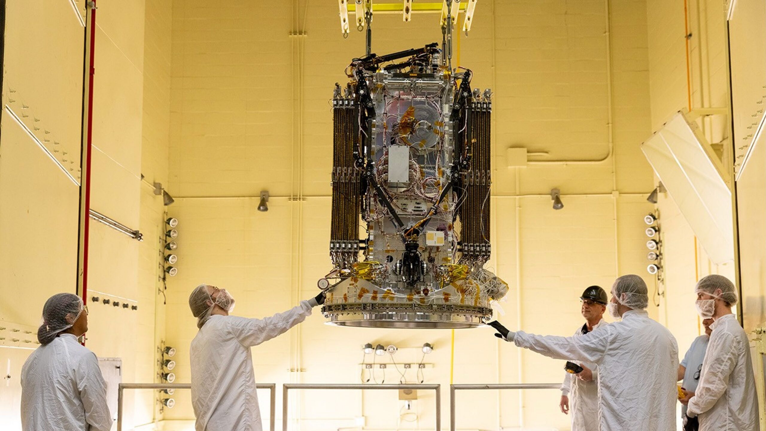 Engineers from Katalyst stabilize their LINK robotic servicing spacecraft as it moves into a vibration chamber at NASA's Goddard Space Flight Center on April 15, 2026.