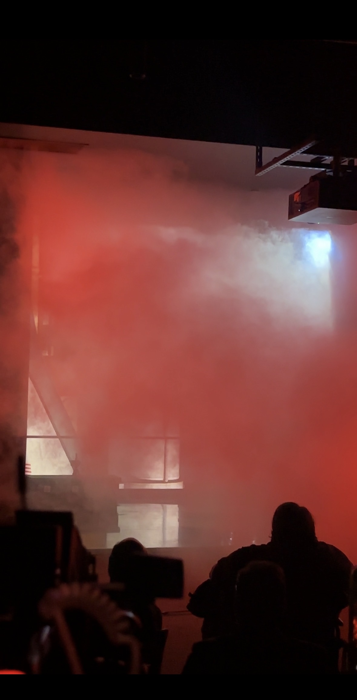 Red smoke thinly veils a shuttle behind it. 