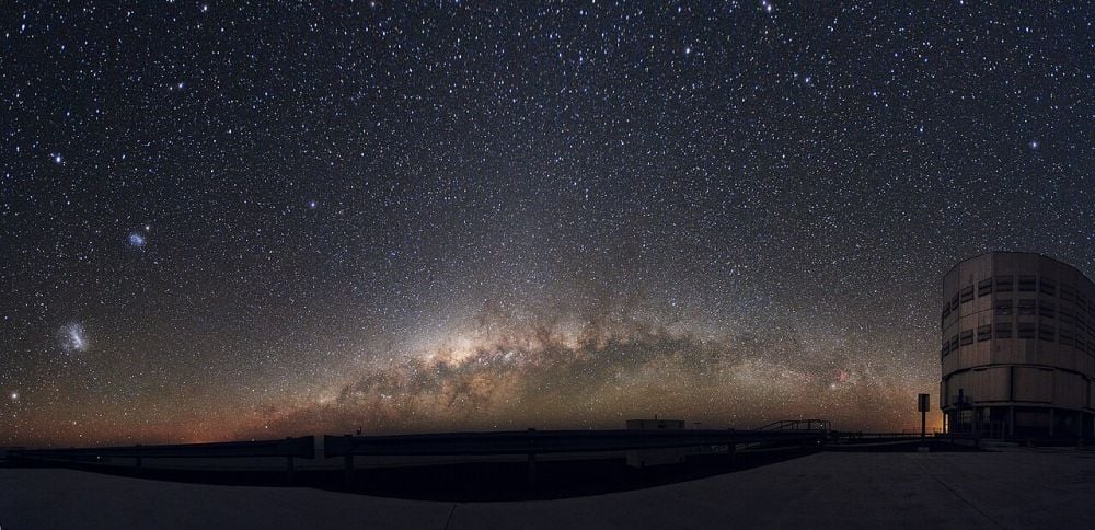 The Large and Small Magellanic Clouds are visible on the left side of this panorama image of the Milky Way taken near the ESO's Very Large Telescope in the Chilean Atacama Desert. About 200,000 light years away, the SMC is a good target for understanding the initial mass fraction and the binary mass fraction of galaxies. Image Credit: By ESO/Y. Beletsky - http://www.eso.org/public/images/potw1114a/, CC BY 4.0, https://commons.wikimedia.org/w/index.php?curid=14788791