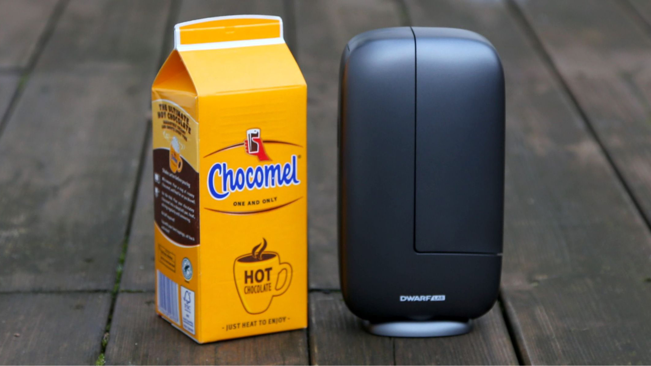 A DwarfLab Dwarf Mini, next to a Chocomel carton for size. They are both the same size.