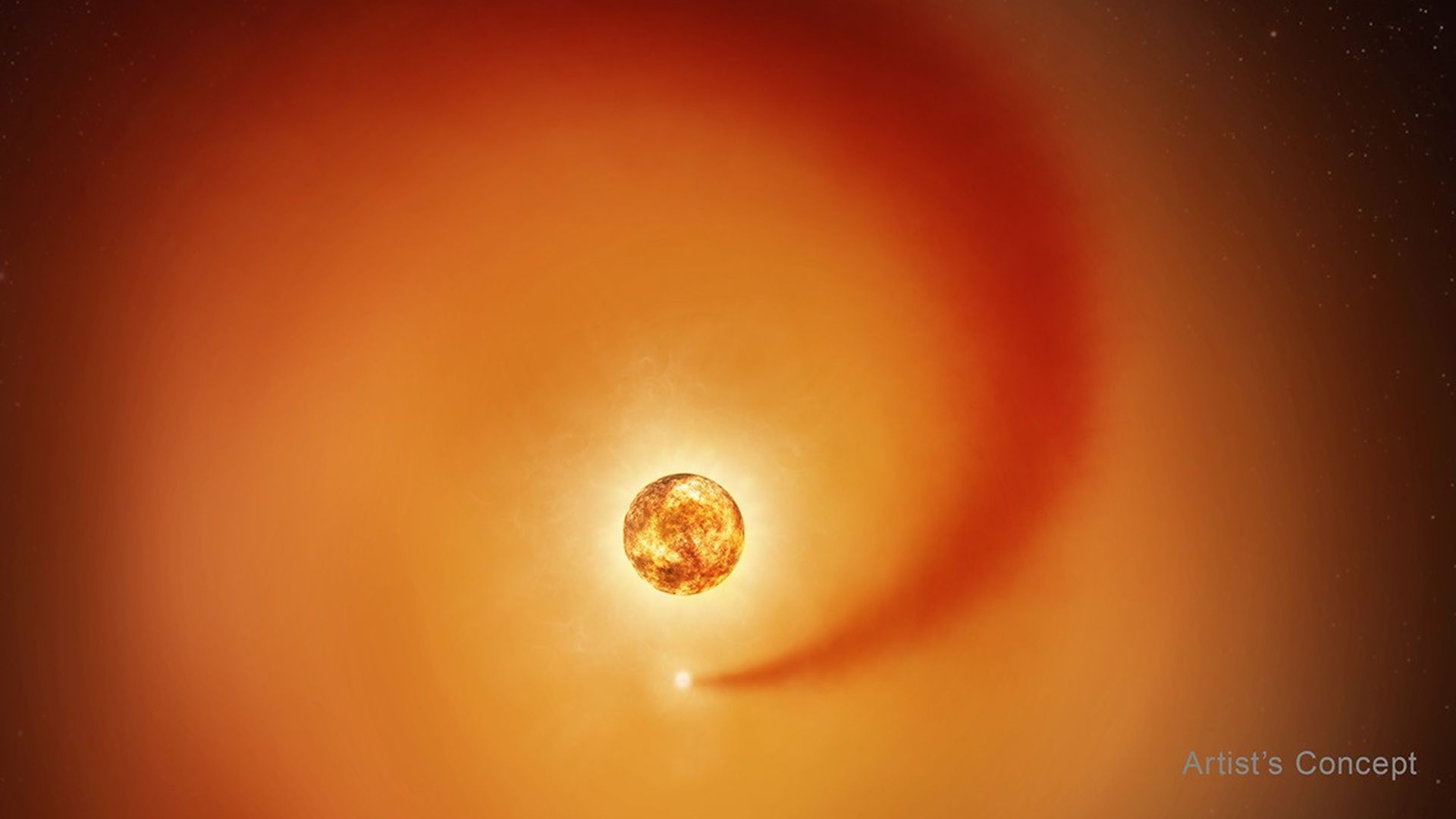 This artist’s concept shows the red supergiant star Betelgeuse and an orbiting companion star.