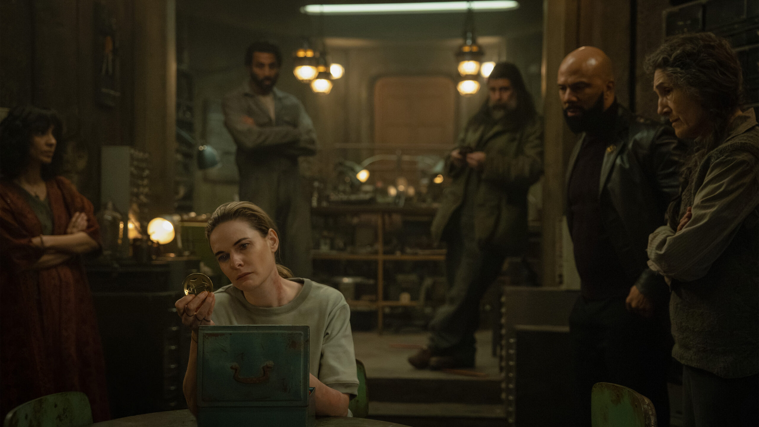 six sci-fi characters in a dark room