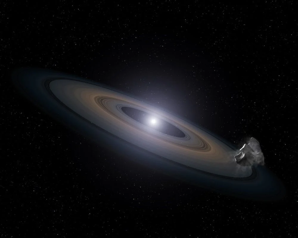 This artist's illustration shows a white dwarf surrounded by a debris disk. Astronomers are finding more and more white dwarfs with metallic debris disks, which suggests the debris comes from planetary systems. New research examines how white dwarfs accrete this debris, showing that it's much more common than thought, and that white dwarfs accrete more planetary debris than thought. Image Credit: NASA, ESA, and G. Bacon (STScI)