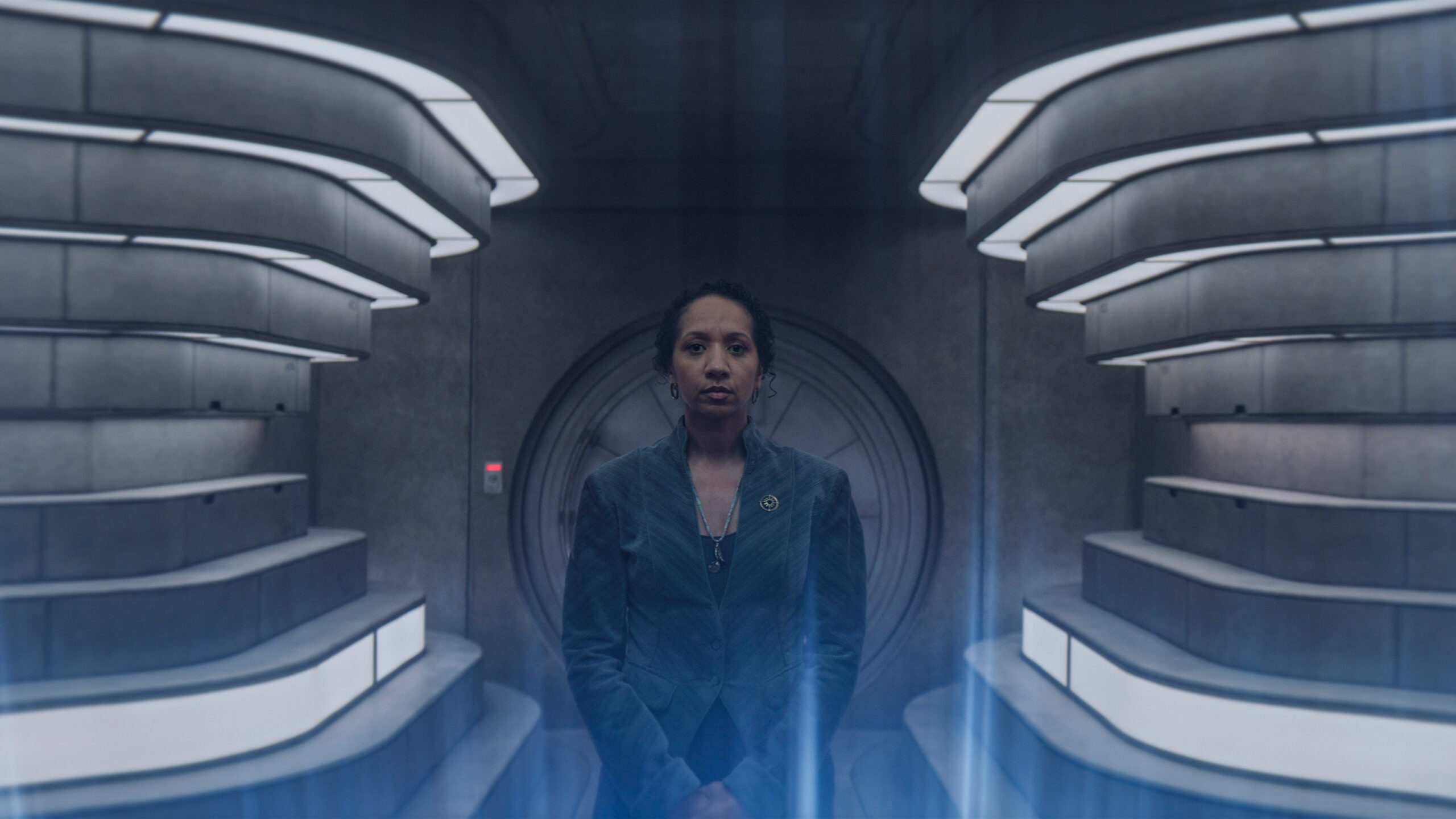 a woman stands in a computer room with illuminated walls