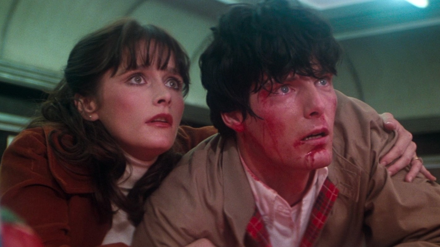 Scene from the movie Superman II (1980). Clark Kent (aka Superman) is battered and bleeding. Lois Lane is holding on to him.