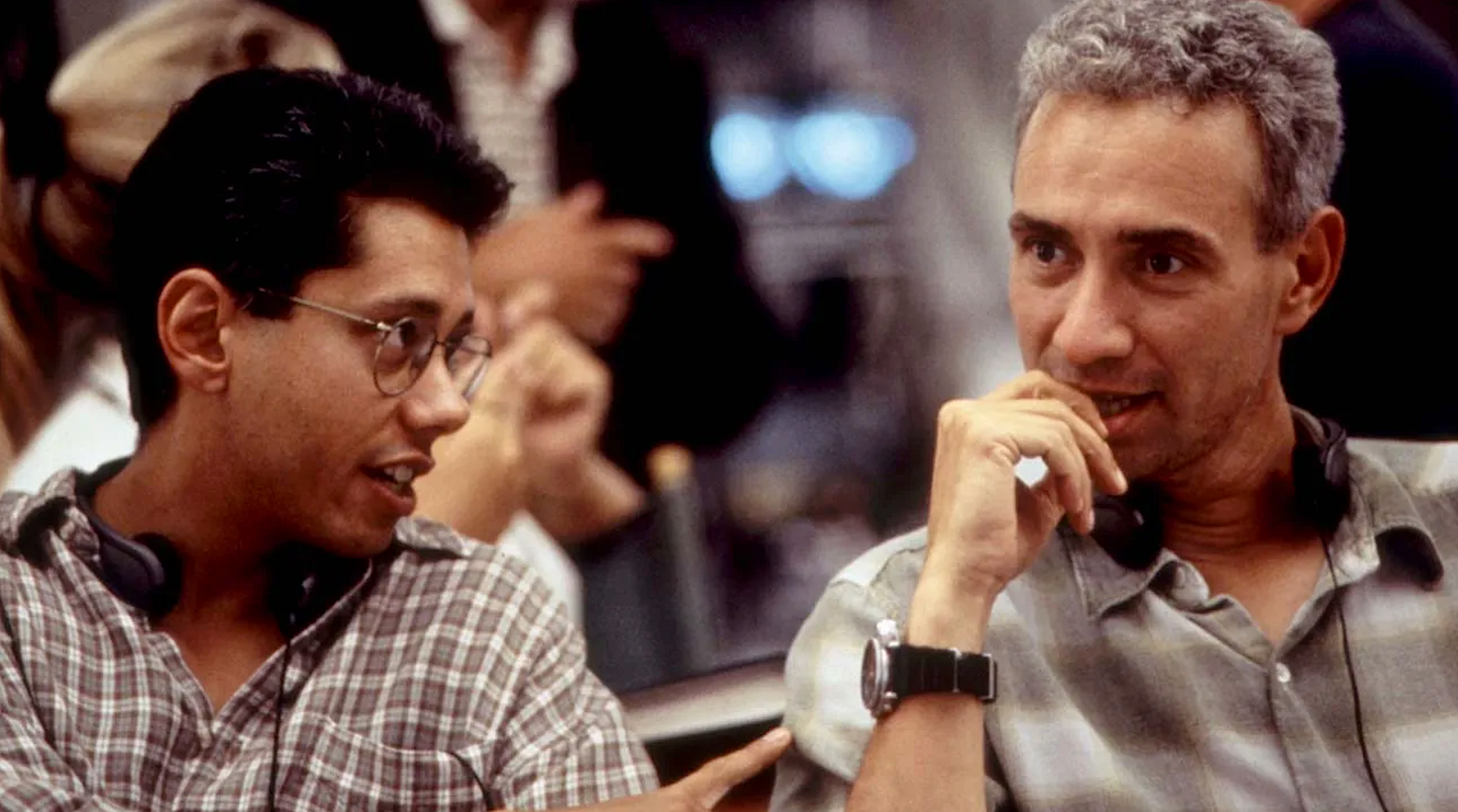 two men conversing on a movie set