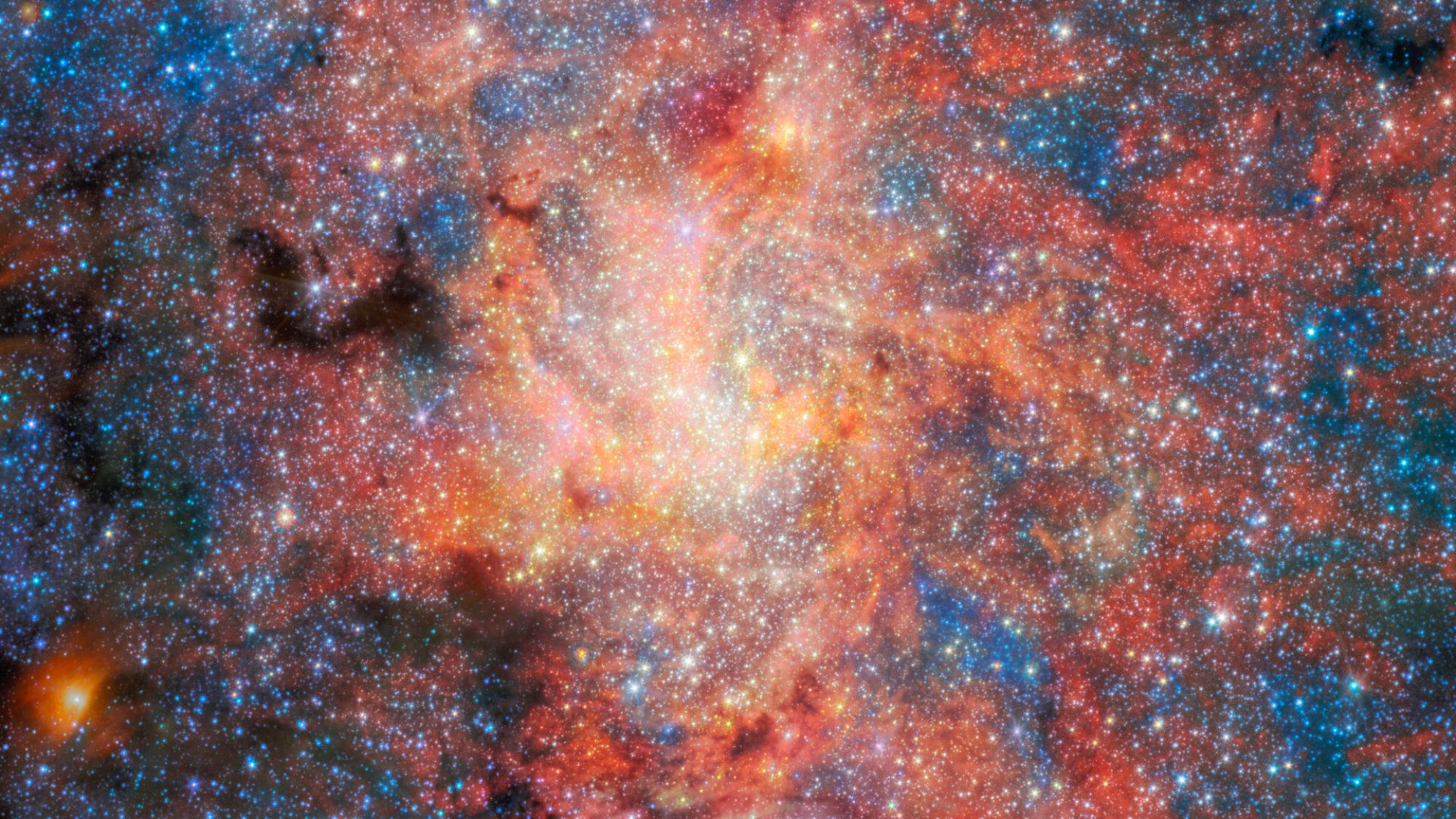A bunch of stars against a reddish structure in space.