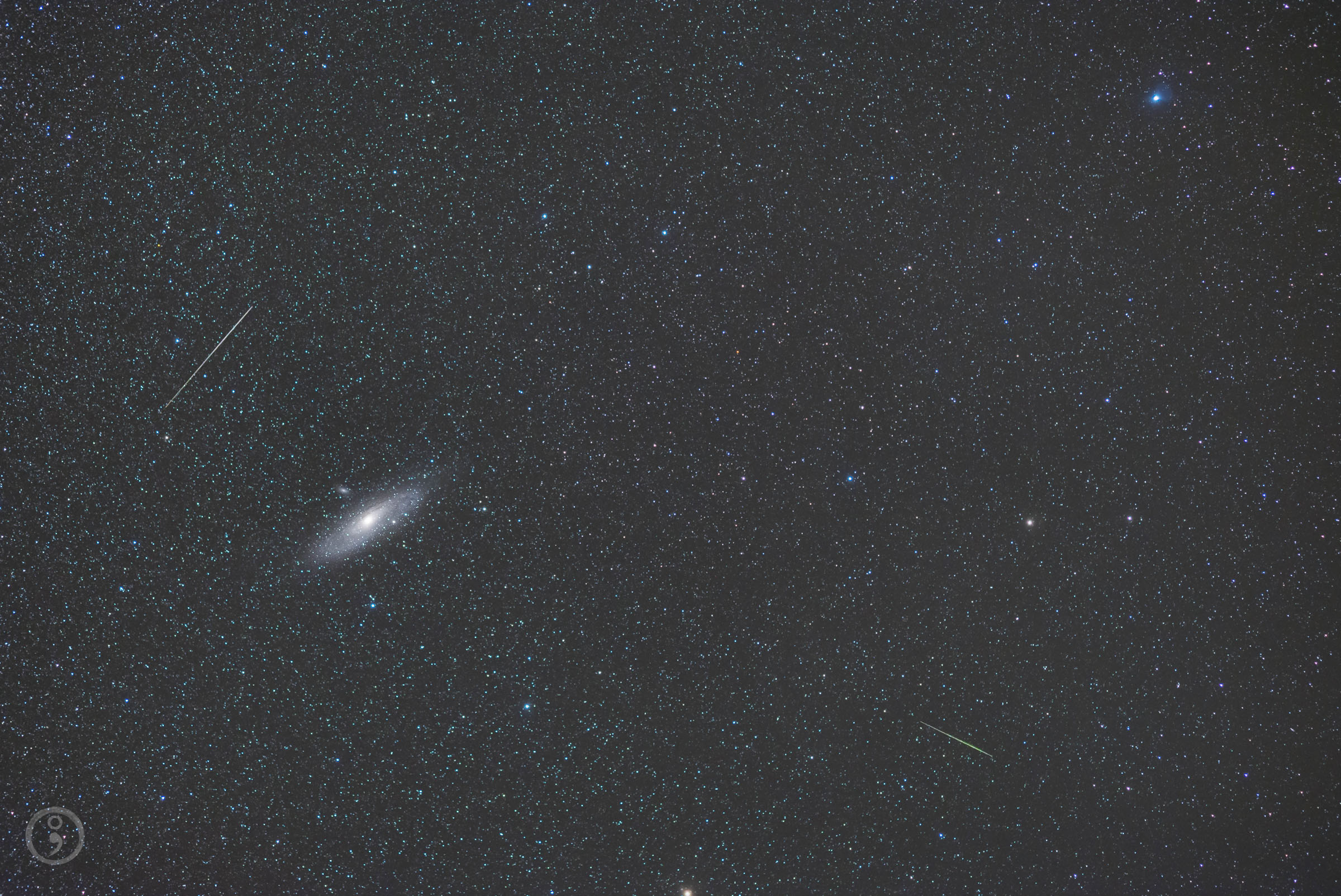 Two meteors dart across the sky near the Andromeda galaxy, the Milky Way's closest galactic neighbor, in this starry image captured by astrophotographer Omid Qadrdan.