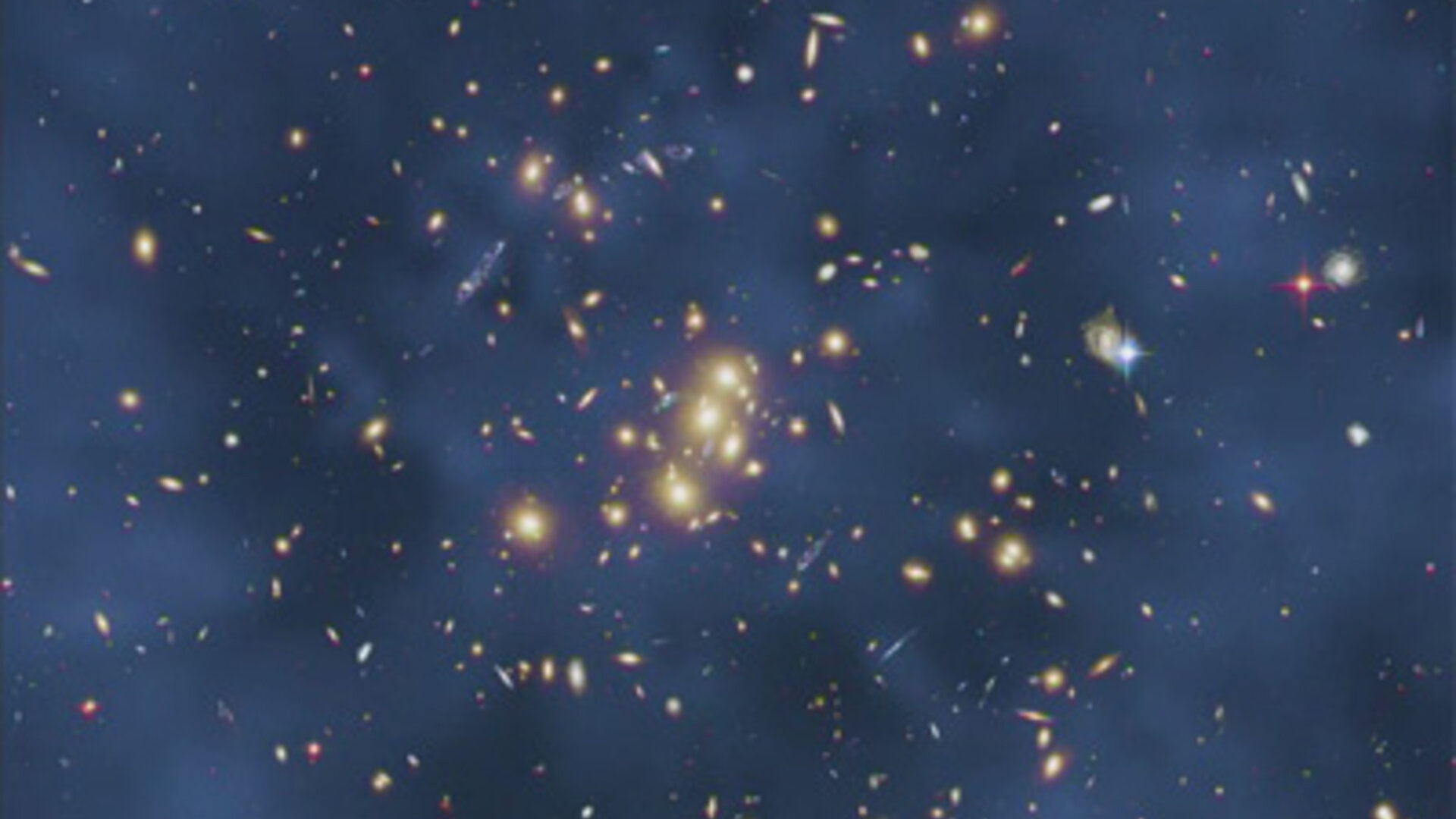 A hazy blue view over a section of space with lots of glowing spots. There is a faint, centered ring visible within the blue haze.
