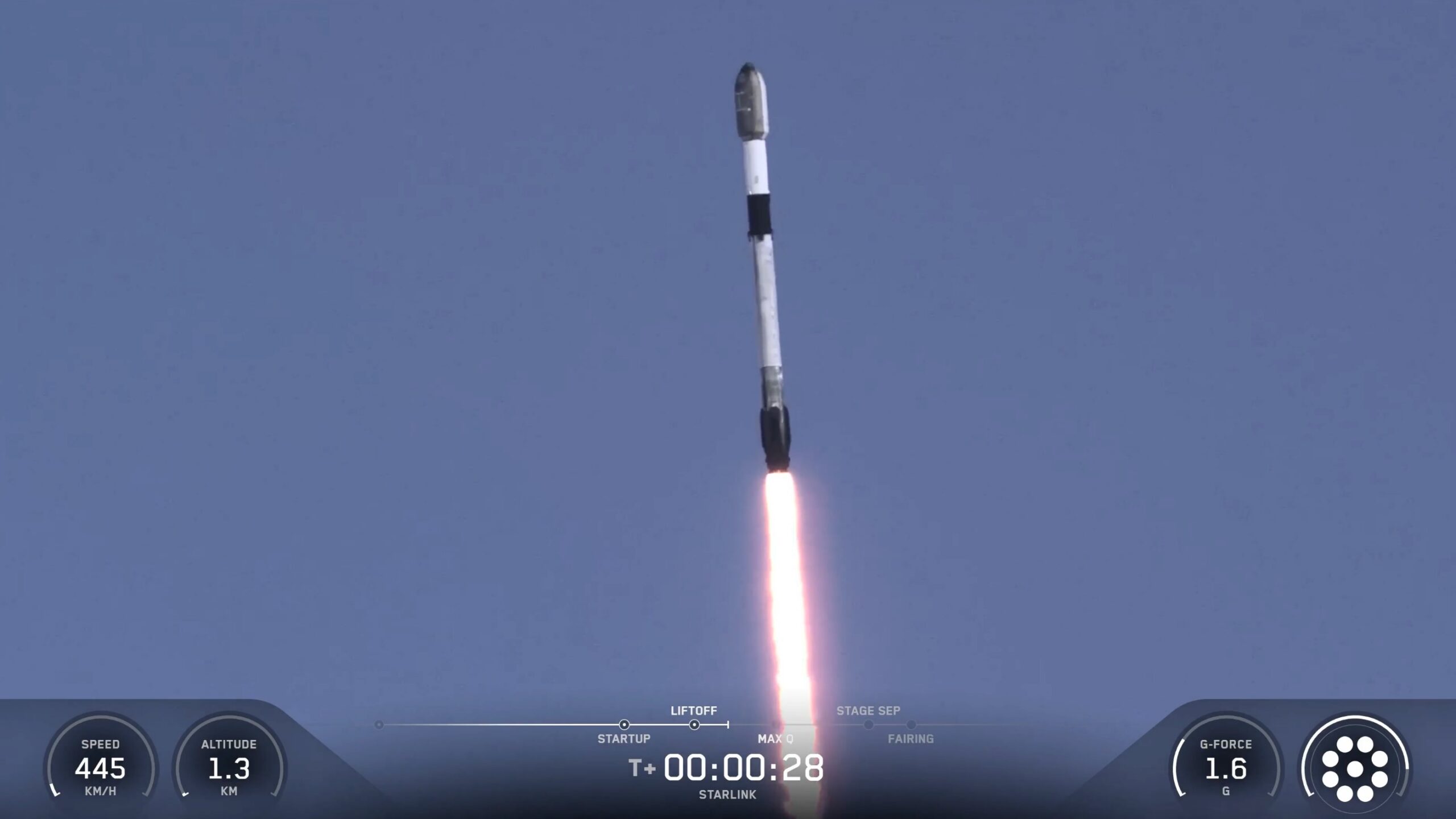 A black-and-white rocket launches into a blue sky