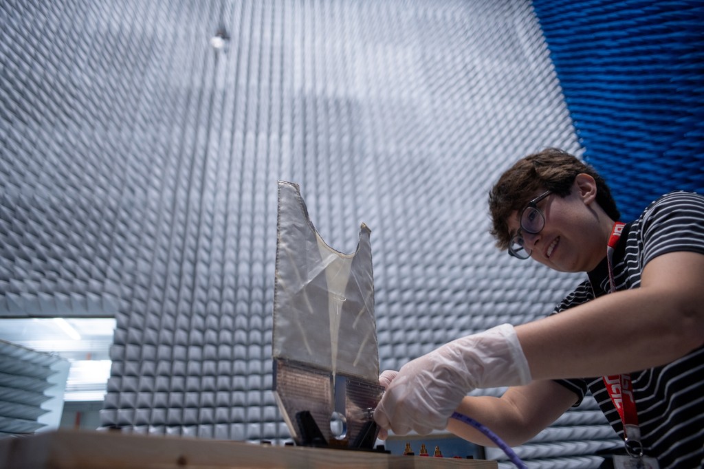 A radar engineer works on a test antenna for the SkyFall mission’s ground-penetrating radar in the electromagnetic interference chamber at JPL.