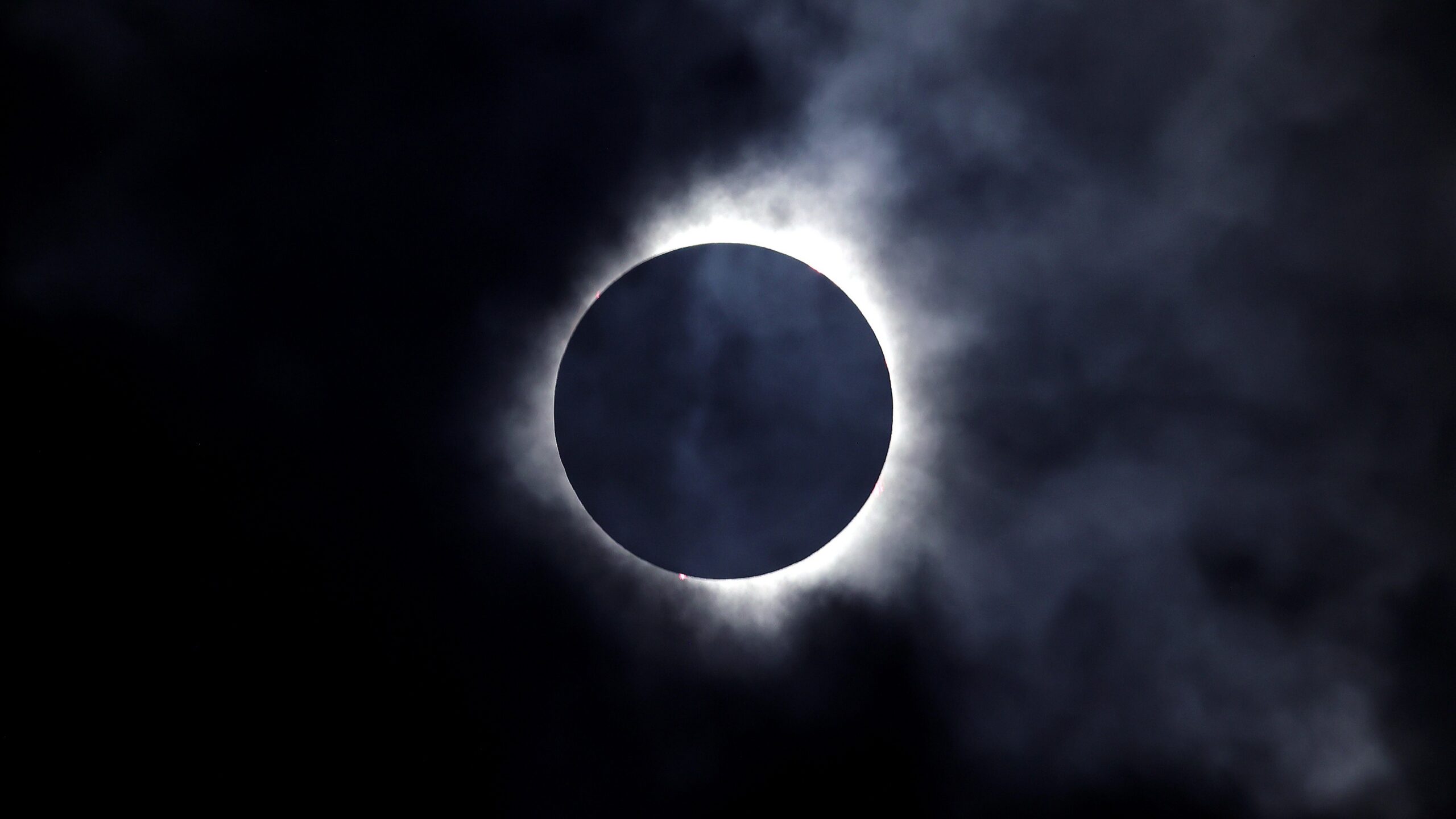 A solar eclipse is seen through the clouds on April 8, 2024 in Niagara Falls, Ontario, Canada.