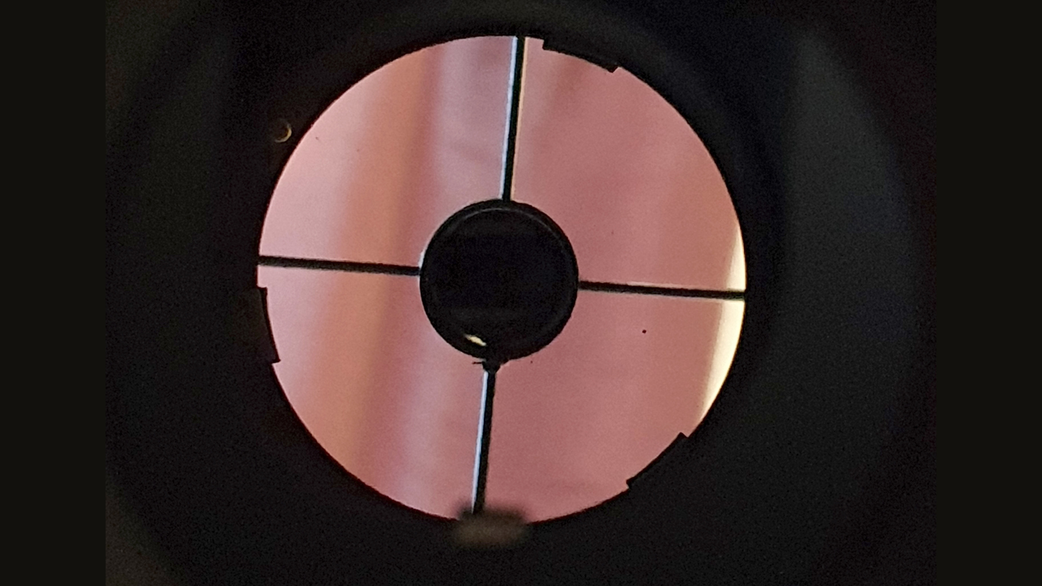 A view down the tube of a telescope as it's being collimated.
