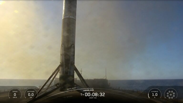 a black and white rocket rests on the deck of a ship at sea