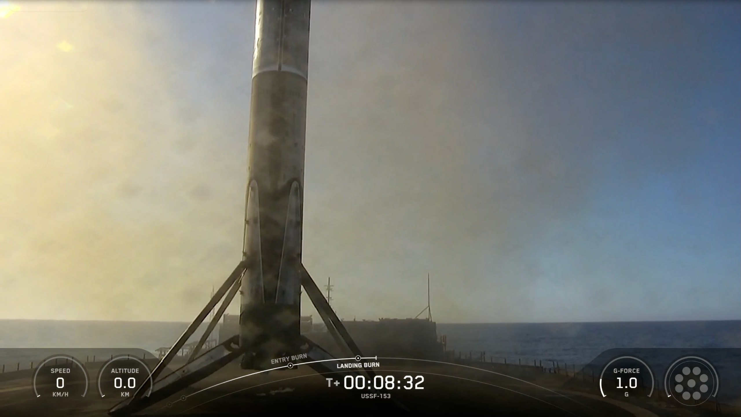 a black and white rocket rests on the deck of a ship at sea