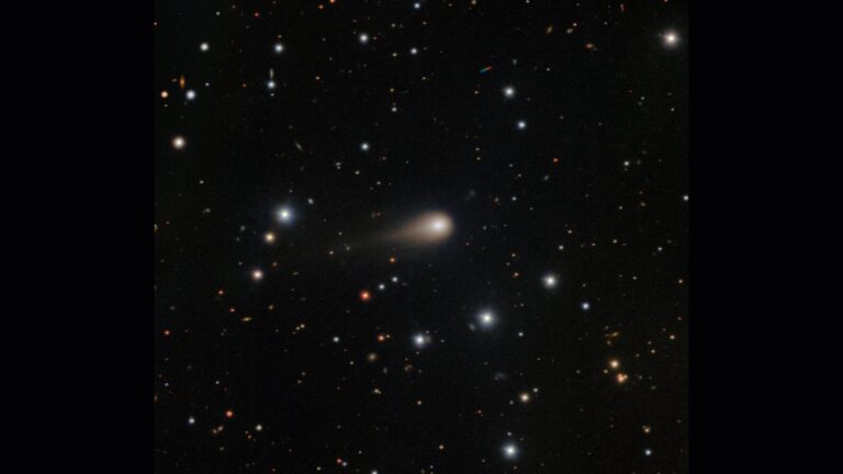 A streak of white shows interstellar comet 3I/ATLAS in the center of a starry night sky