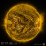 A view of a yellow sphere with some flares coming off of it.