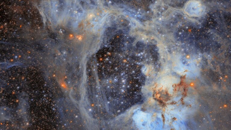 Lots of sparkles and glowing dots among smoky tendrils of gas.