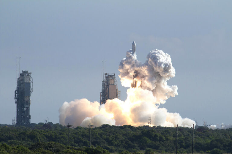 A rocket launches and is engulfed in exhaust