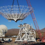 A crane lowers a giant NASA radio dish into place while building Deep Space Station 23 on Dec. 18, 2024.