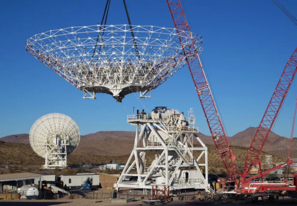 A crane lowers a giant NASA radio dish into place while building Deep Space Station 23 on Dec. 18, 2024.