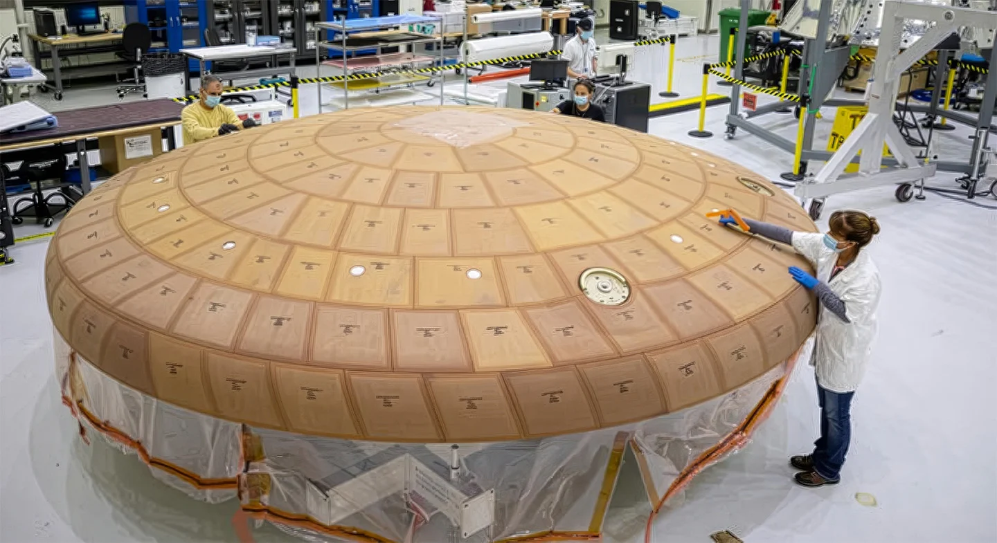Engineers working on the Artemis II heat shield at the Kennedy Space Center. Credit - NASA