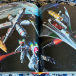an open book with pages depicting space art