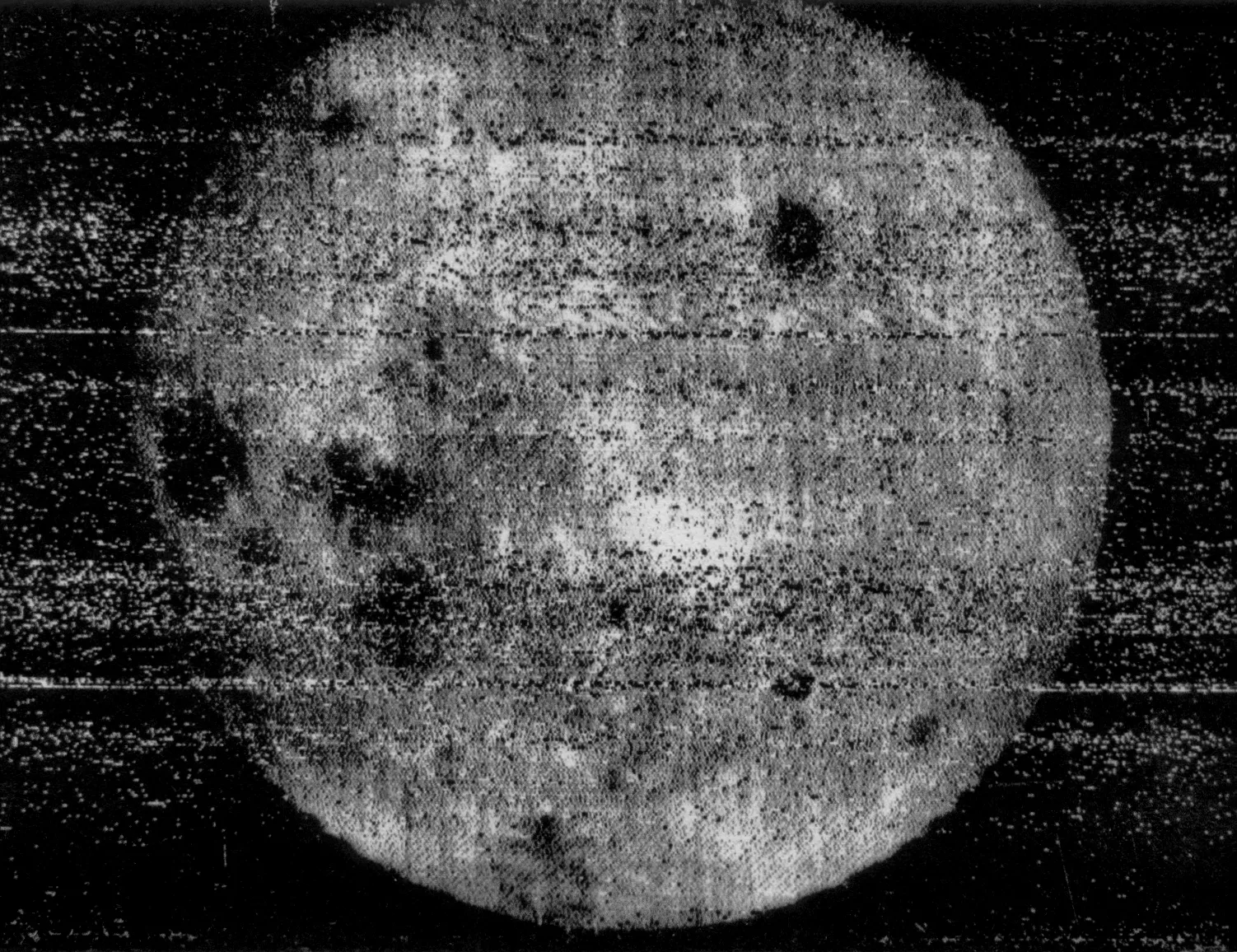 A grainy, black-and-white, highly textured image shows a circular, full sphere centered against a dark background. The spherical surface is pale grey and mottled with prominent dark blotches, accompanied by heavy horizontal static lines and speckles running across the entire frame. High contrast separates the bright, rough-textured sphere from the surrounding dark space.