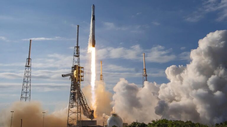 a black and white rocket launches into a blue sky
